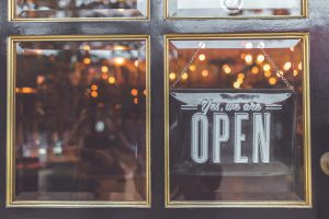 photo of a retail storefront with an open sign after being power washed