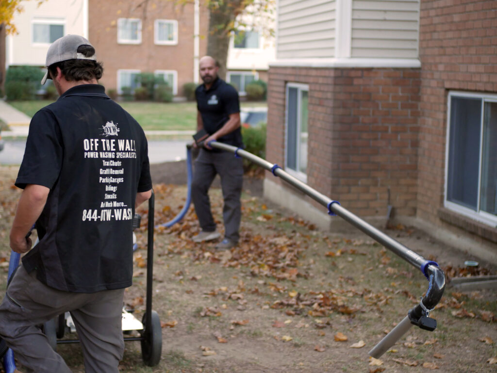 photo of a team member setting up the 40 foot gutter cleaning unit