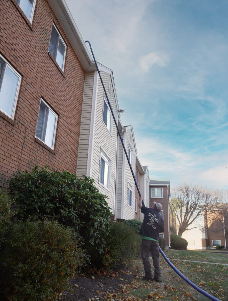 photo of a team member removing debris during a gutter cleaning in ct